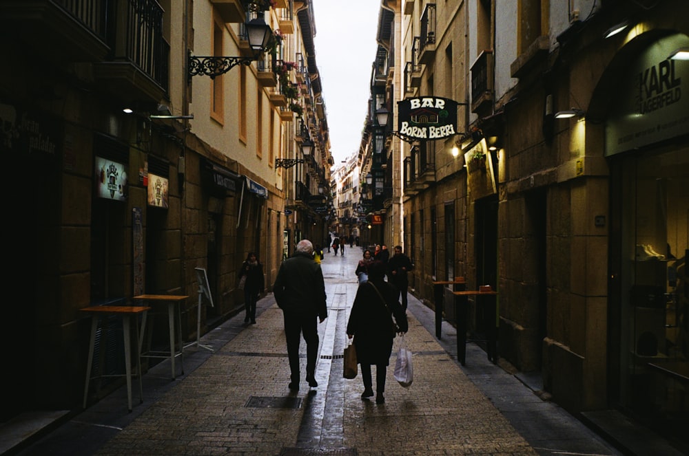 a couple of people that are walking down a street