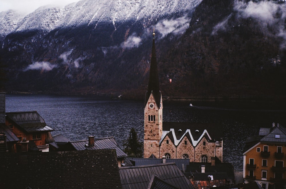 a church steeple with a mountain in the background