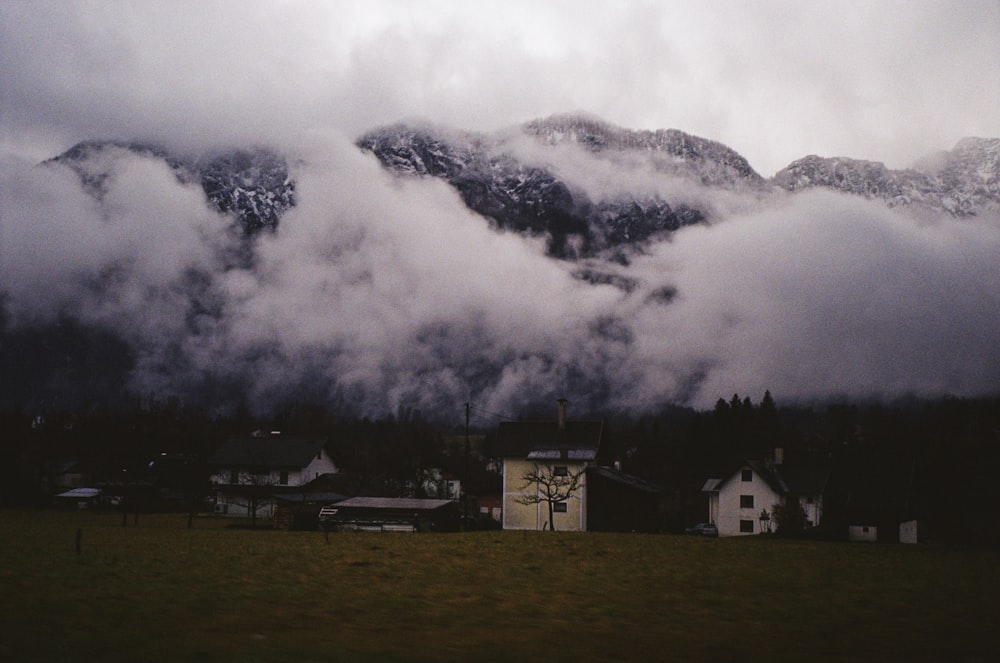 a mountain range covered in clouds and houses