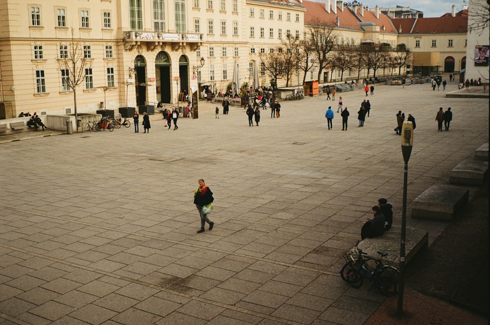 a group of people walking around a large courtyard