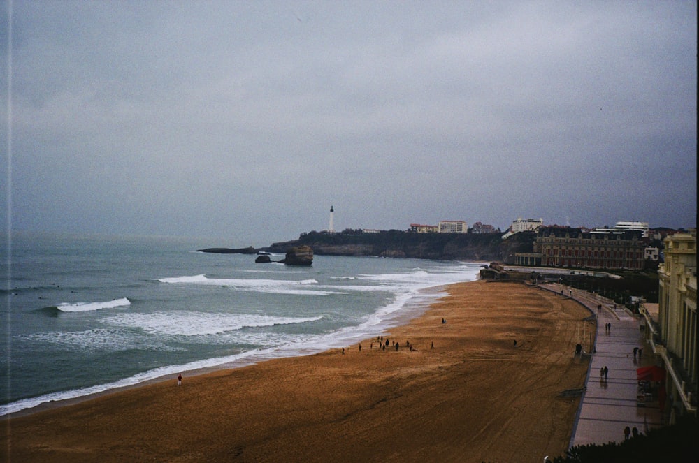 a view of a beach with a lighthouse in the distance