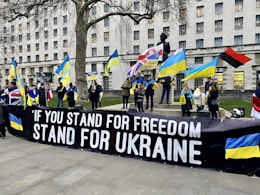 a group of people holding flags and a banner