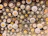 Close-up of colorful sewing buttons neatly arranged on a wooden table.