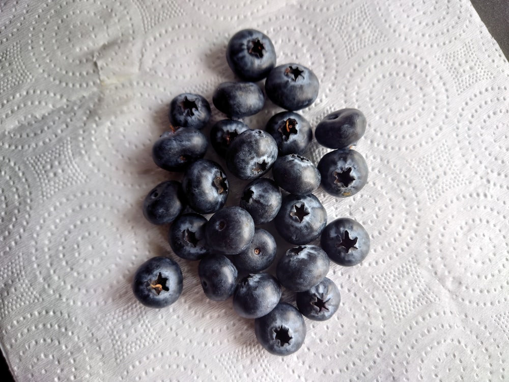 a pile of blueberries sitting on top of a table