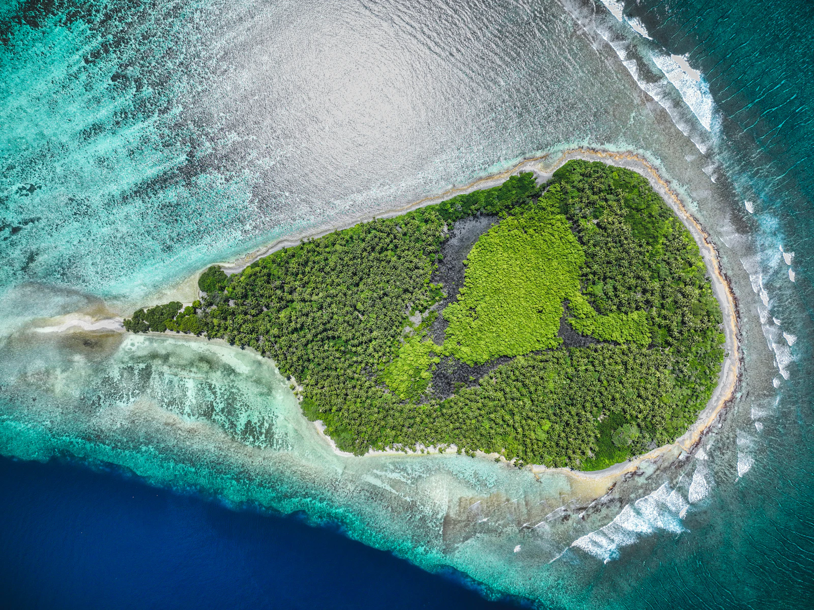 Aerial view of a small desert island surrounded by open ocean