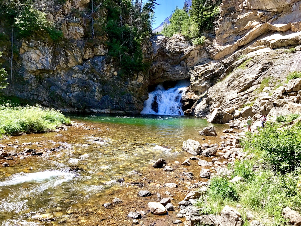 a small waterfall in the middle of a canyon