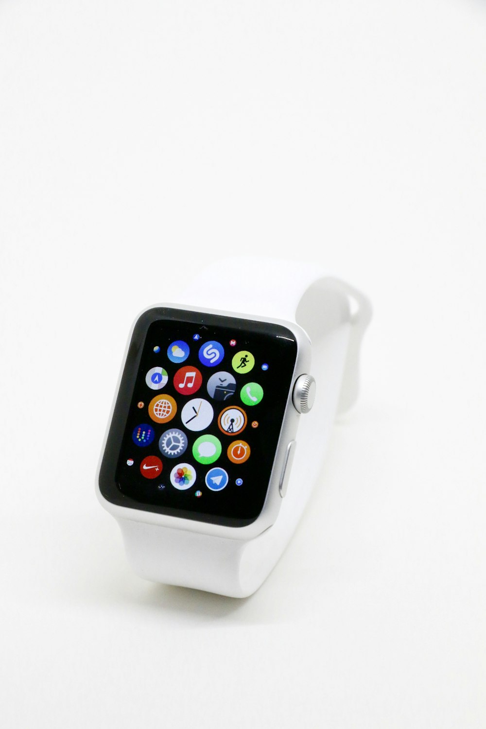 a white apple watch sitting on top of a white table
