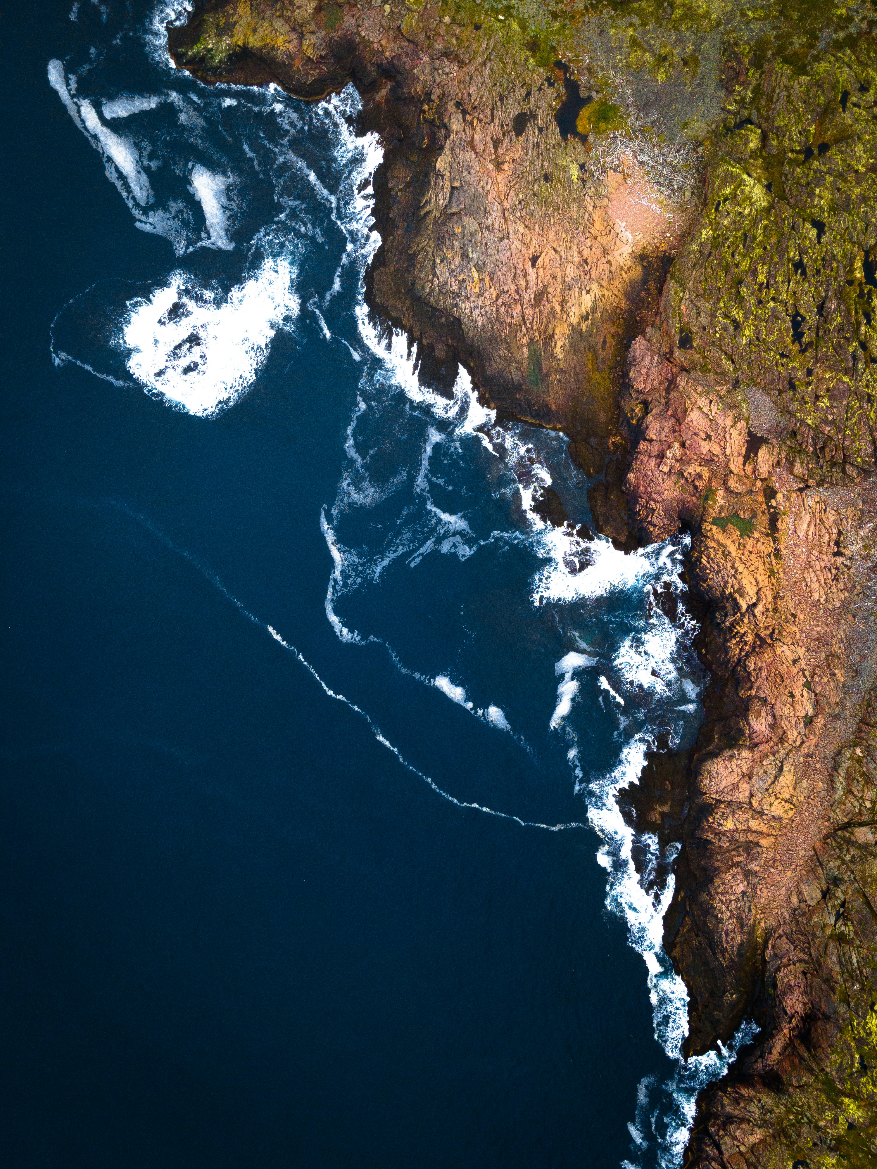 an aerial view of the ocean and land