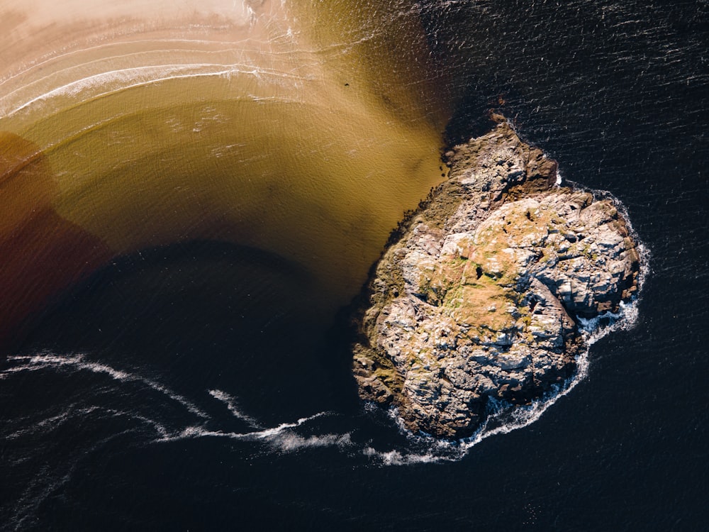 an aerial view of a rock formation in the ocean