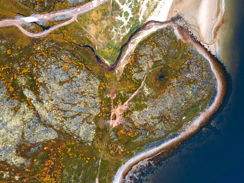 an aerial view of a river and land