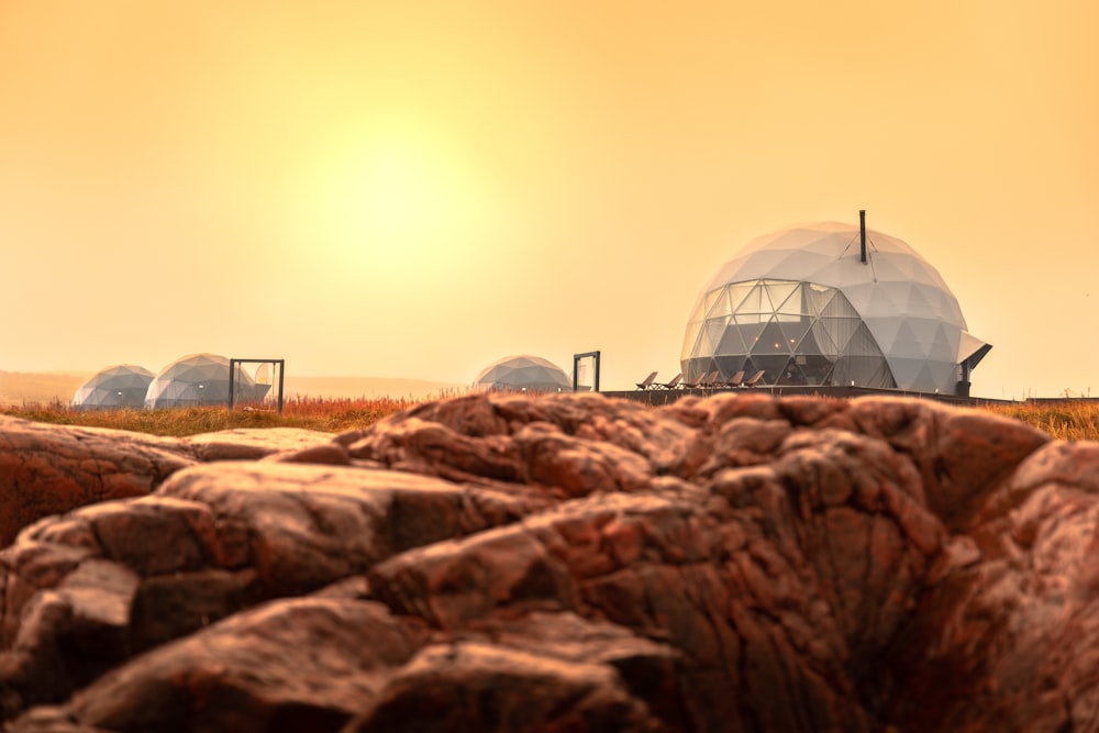 a group of domes sitting on top of a rocky hillside