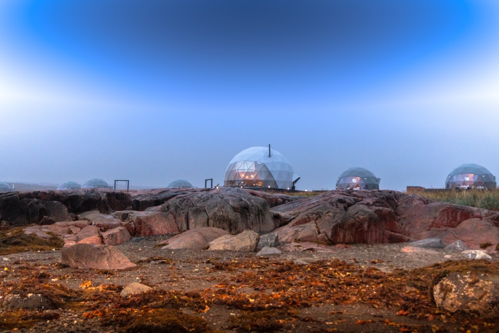 a group of domes sitting on top of a rocky hillside
