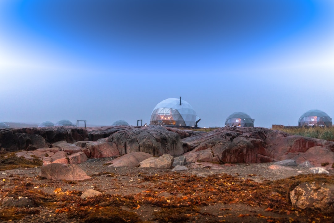 a group of domes sitting on top of a rocky hillside,