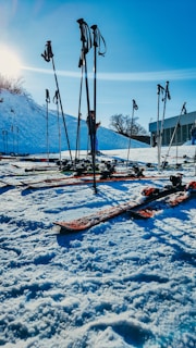 Close-up of ski boots and poles neatly arranged on snow.