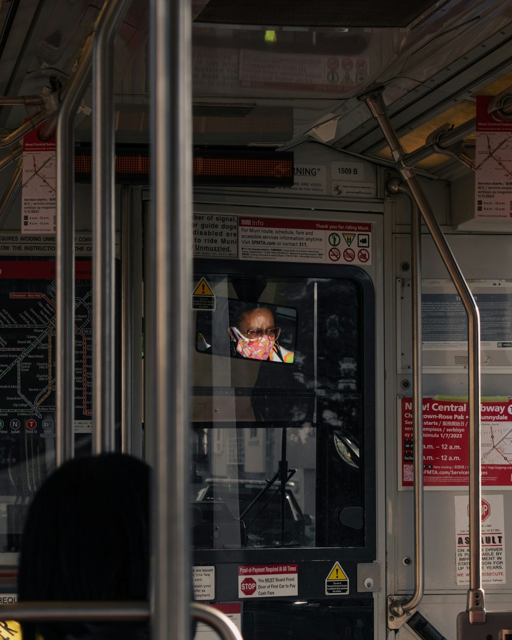 a man sitting in a bus looking out the window