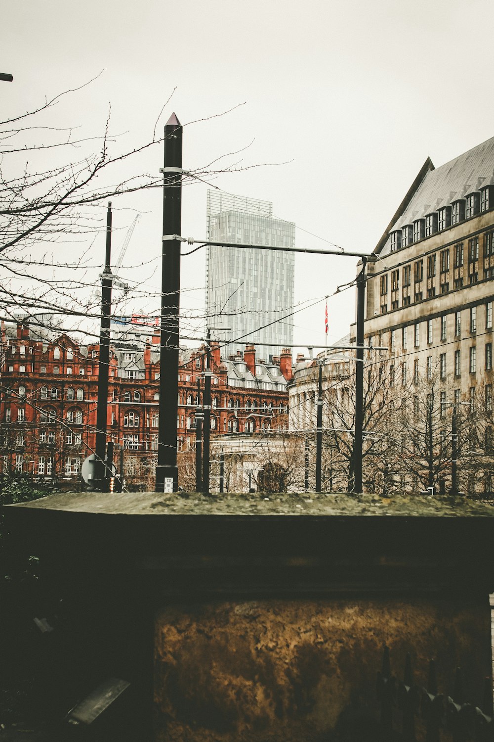 a view of a city from behind a fence