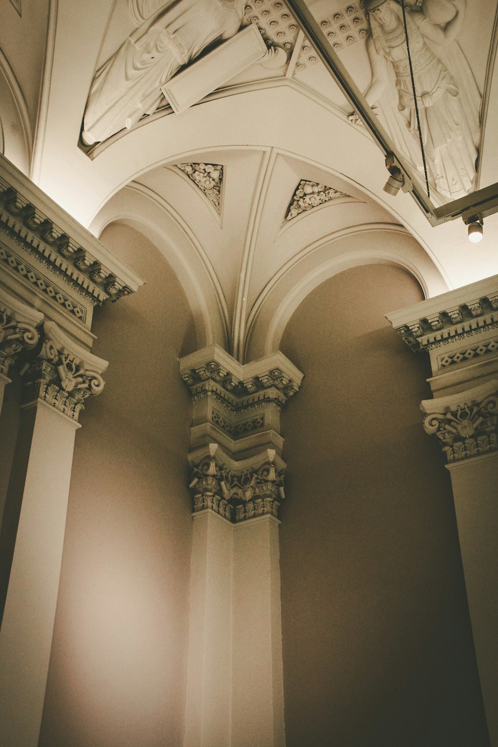 the ceiling of a building with a clock on it