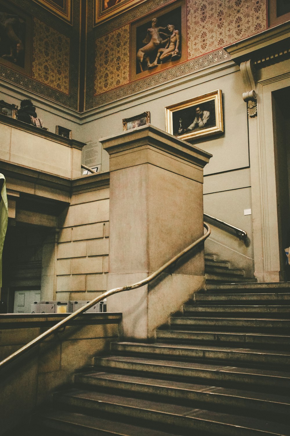 a staircase leading up to a painting on the wall