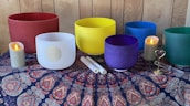 Tibetan singing bowls arranged on a wooden surface with soft candlelight.