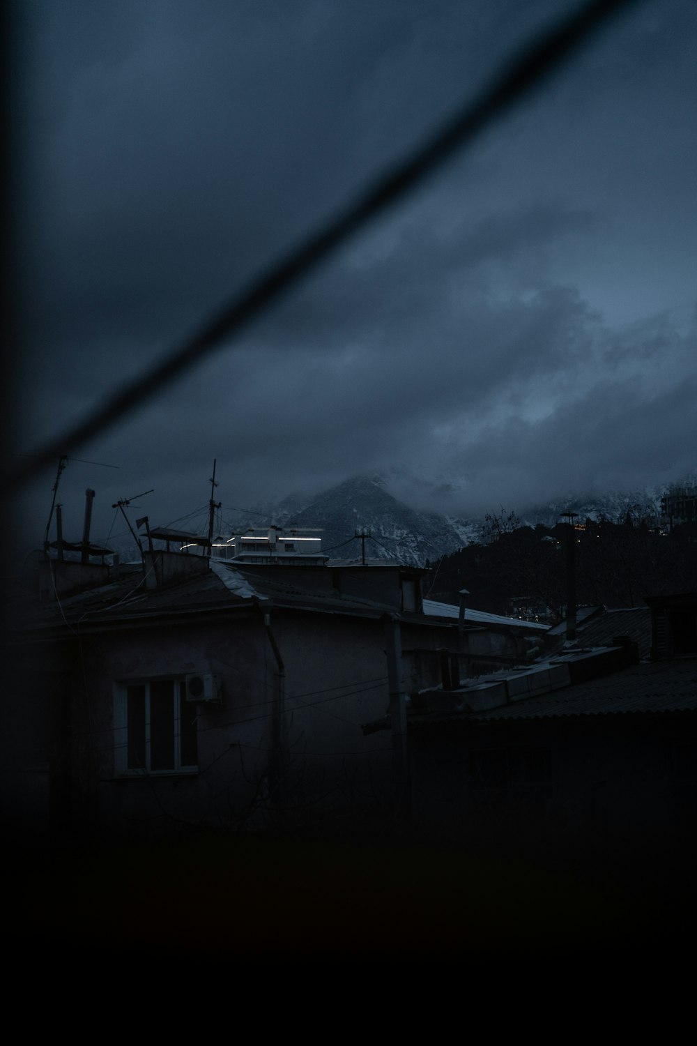 a dark sky with a mountain in the background