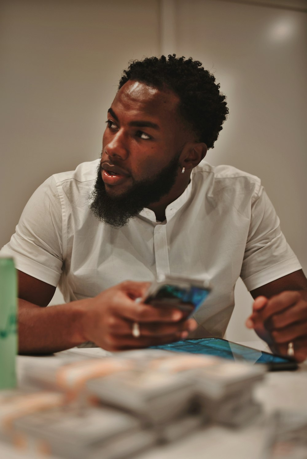 a man sitting at a table looking at his cell phone