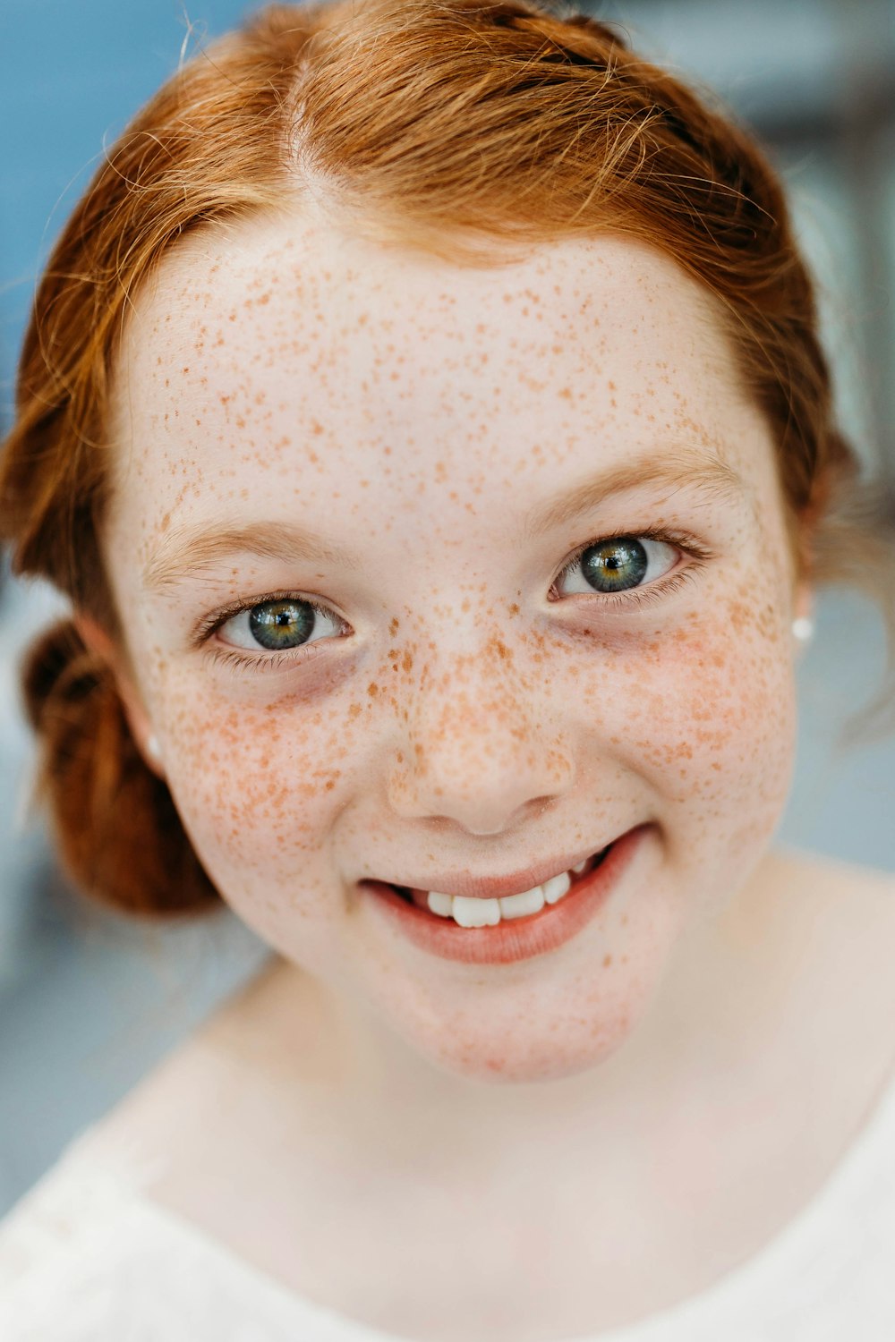 a young girl with freckles on her face