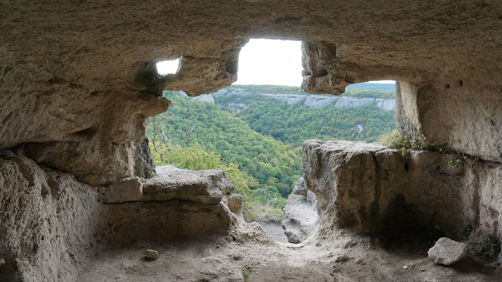 a view of a valley through a stone window