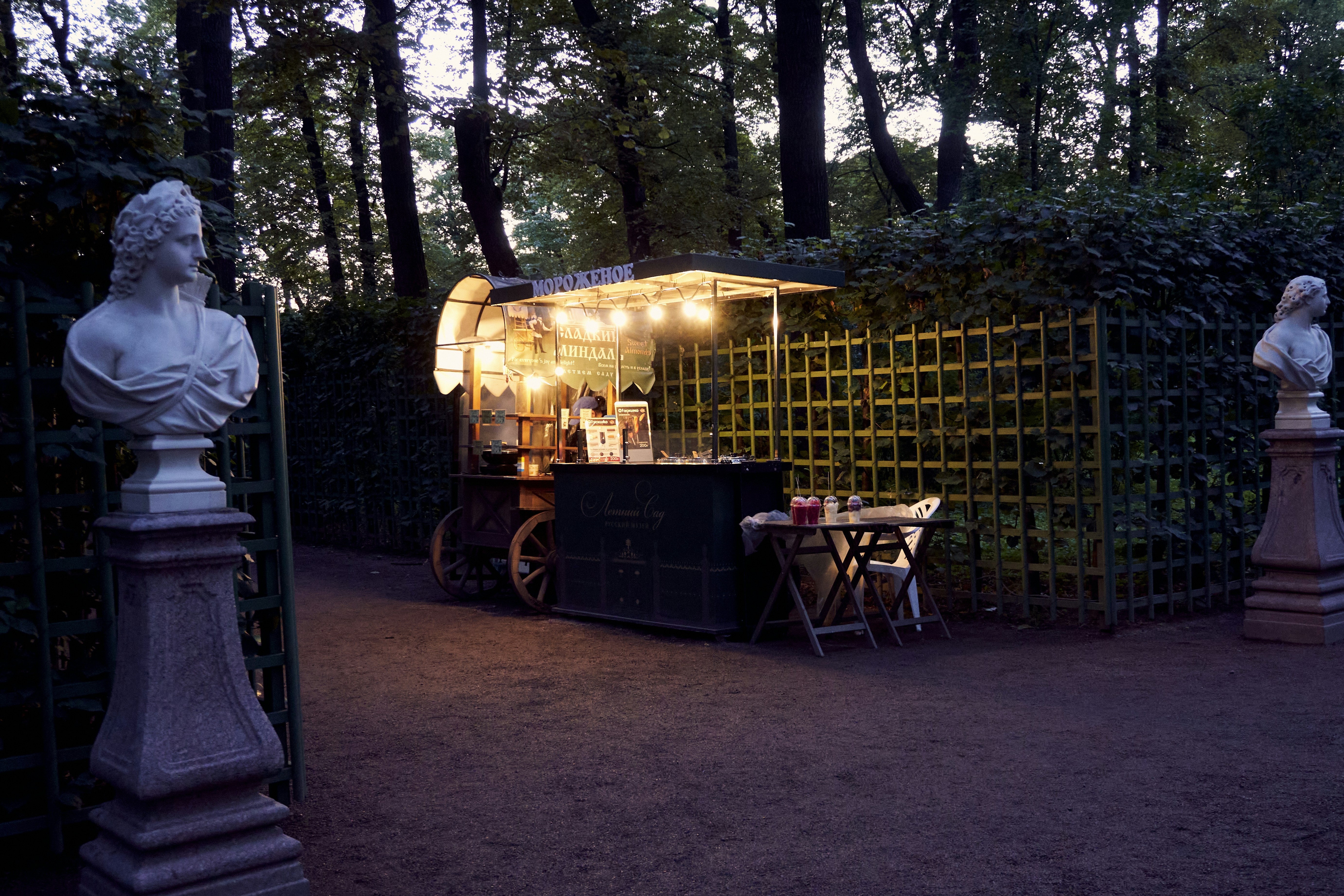 a food cart with a statue of a woman in front of it