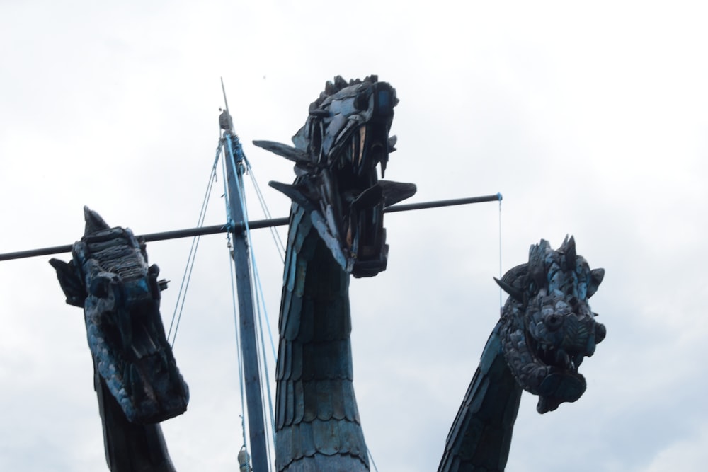 a statue of a dragon with a boat in the background