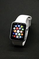 A sleek, modern smartwatch with a vibrant display glowing in a dark setting