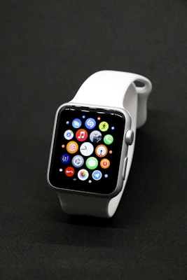 A stylish smartwatch with a vibrant screen glowing against a simple, uncluttered backdrop.
