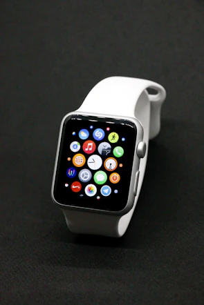 Sleek smartwatch displaying notifications on its vibrant screen against a minimalist backdrop.