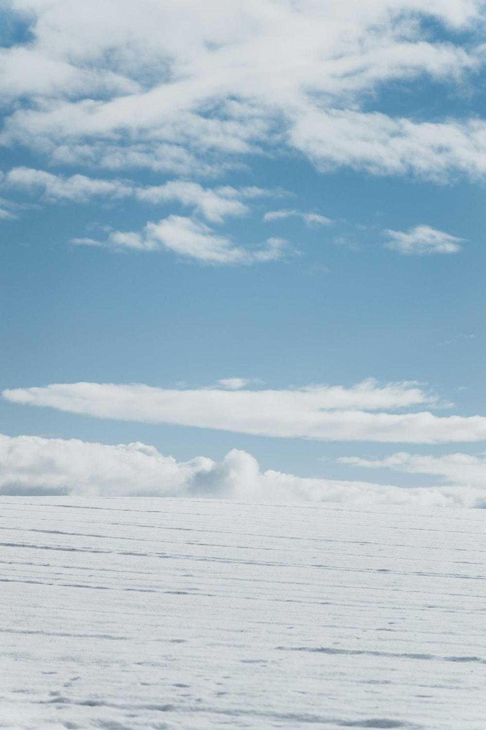 a person walking across a snow covered field