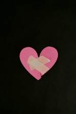 a pink heart cut out of a piece of paper