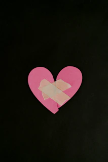 a pink heart cut out of a piece of paper