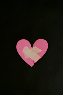 a pink heart cut out of a piece of paper