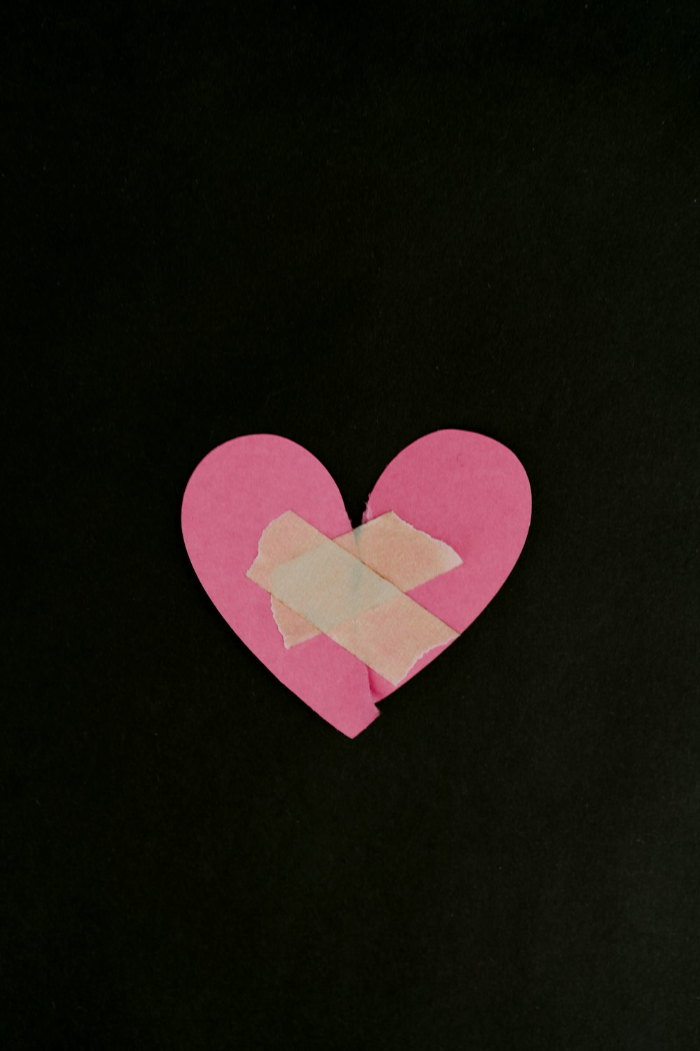 a pink heart cut out of a piece of paper