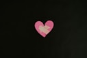 a pink heart cut out of a piece of paper
