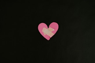 a pink heart cut out of a piece of paper