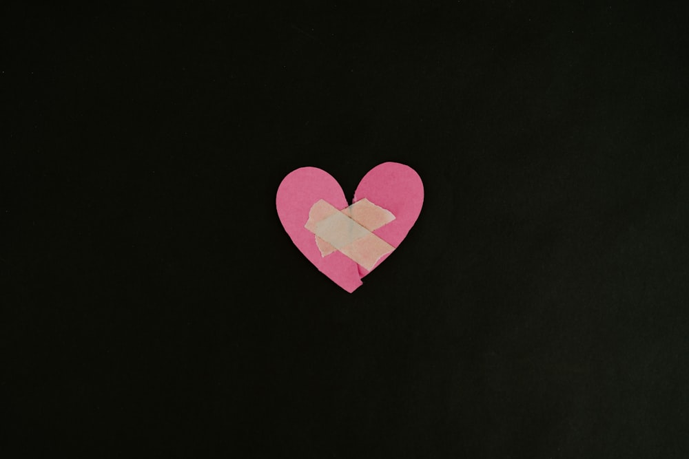 a pink heart cut out of a piece of paper