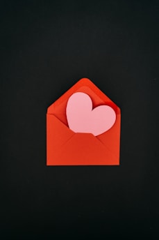a red envelope with a heart cut out of it