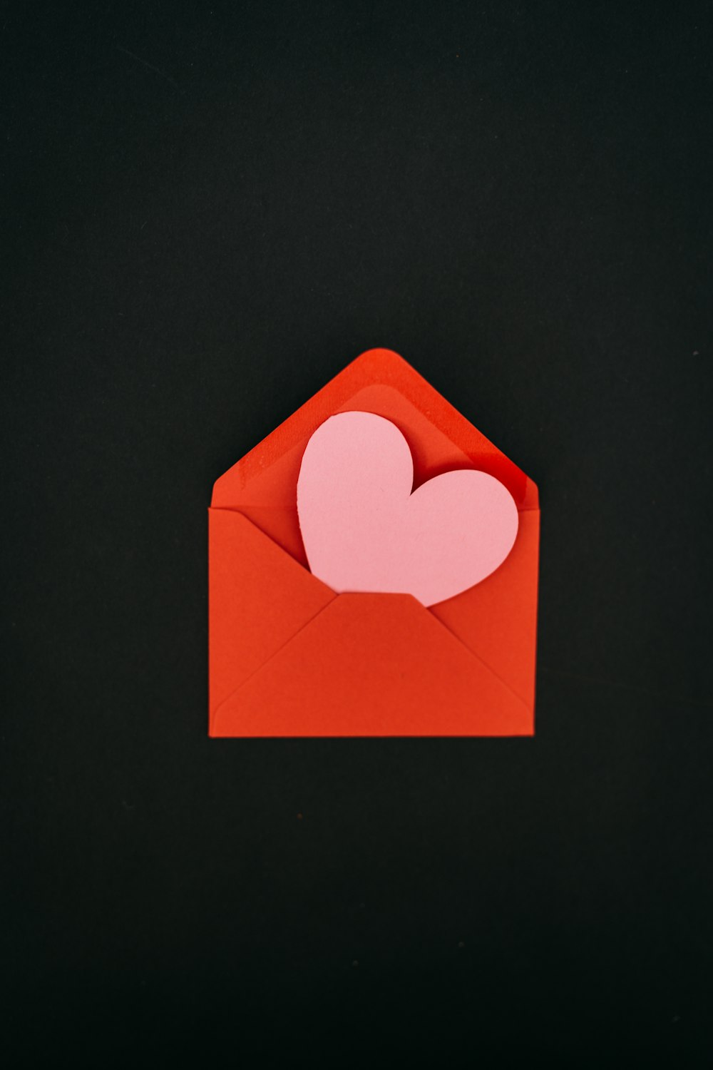 a red envelope with a heart cut out of it