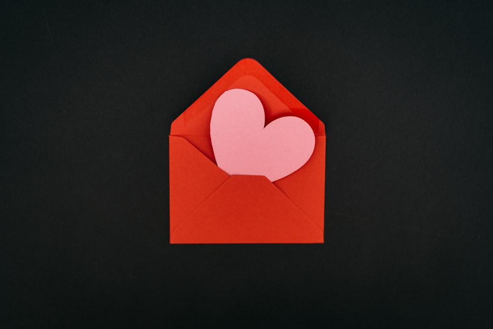 a red envelope with a heart cut out of it