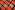 a close up of a piece of brown paper with black and orange squares