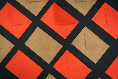 a close up of a piece of brown paper with black and orange squares