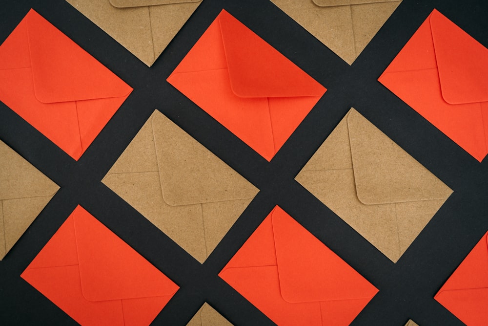 a close up of a piece of brown paper with black and orange squares