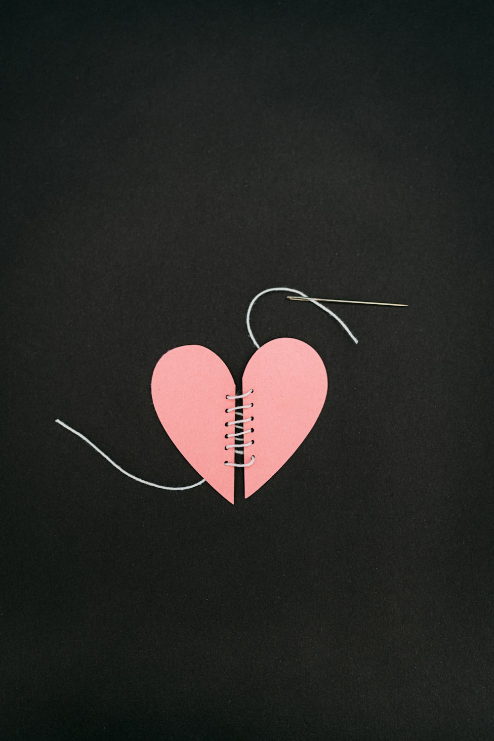 a broken heart with a string attached to it