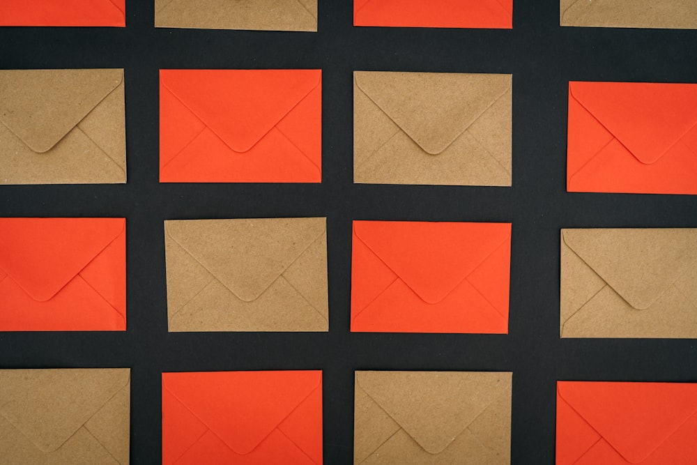 an orange and black background with several envelopes