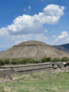 A joyful family exploring ancient pyramids under a bright blue sky