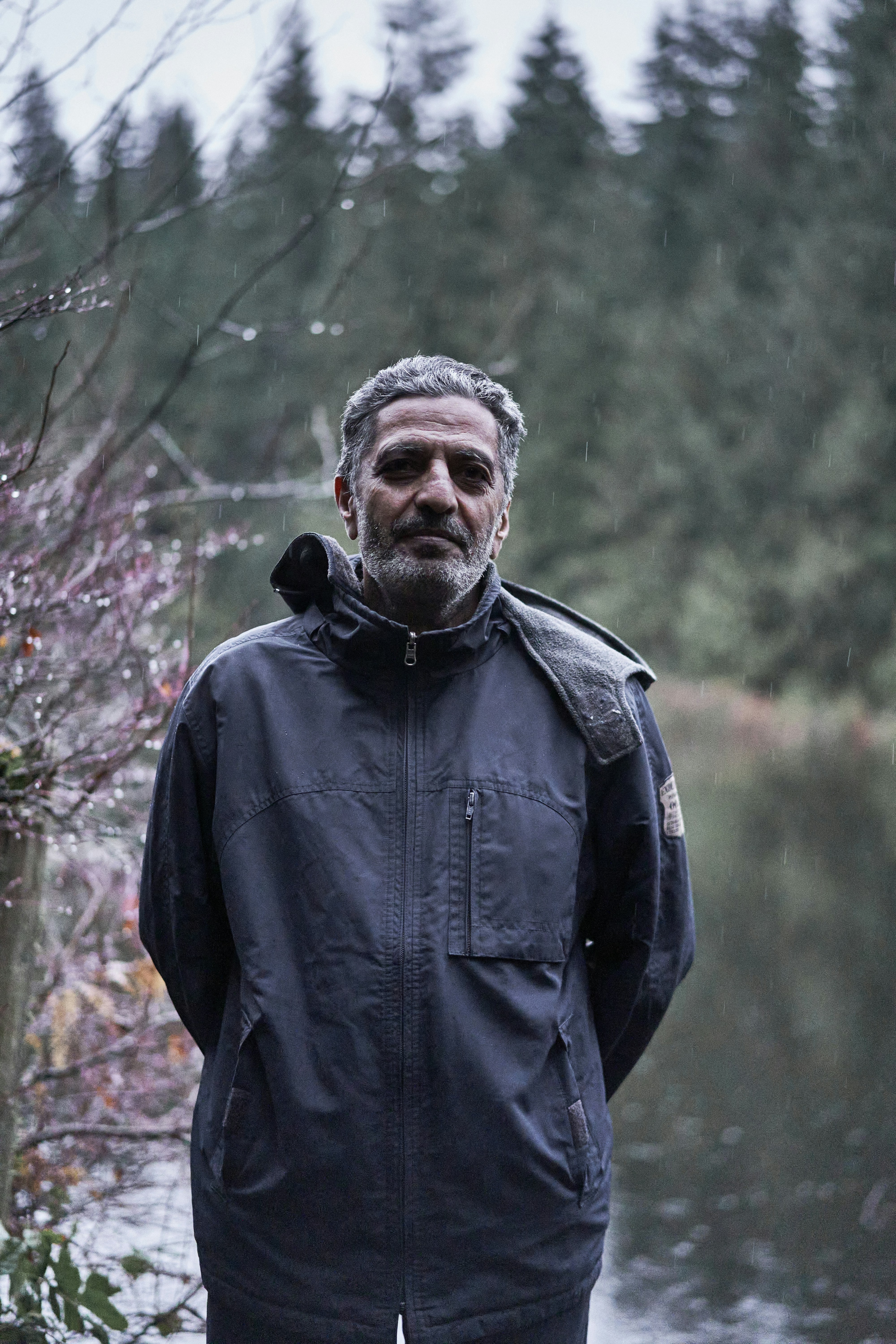a man standing in front of a body of water